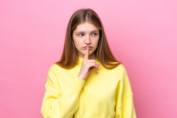 Teenager Russian girl isolated on pink background showing a sign of silence gesture putting finger in mouth