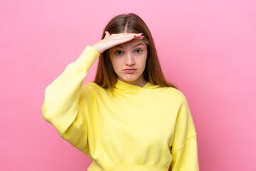 Teenager Russian girl isolated on pink background looking far away with hand to look something