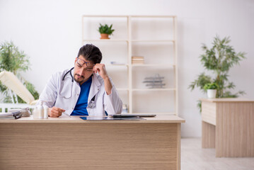 Young male doctor working in the clinic