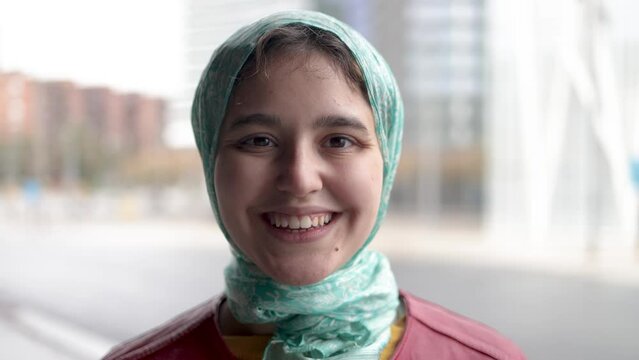 Happy Muslim girl smiling on camera outdoor