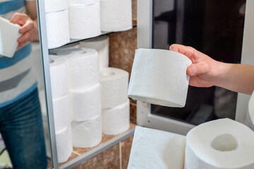 A man is stocking up toilet paper at home. Consumer buying panic about coronavirus covid-19...