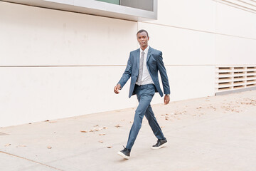 african american businessman walking looking at camera