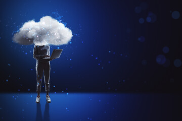 Fototapeta Cloud headed hacker with laptop standing on abstract blue bokeh interior background with mock up place. Sky is the limit, motivation concept. obraz