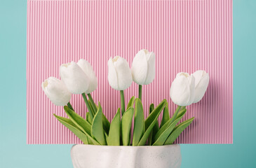 Tulip flowers in a vase against the corrugated pink background. Spring, summer floral concept.