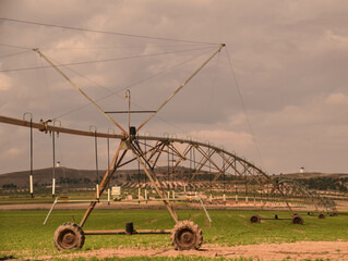 Mechanical irrigation of motorized cultivation field