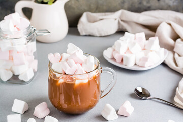 Sweet cocoa with heart-shaped marshmallows in a cup and saucer
