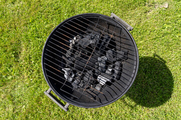 Close up of round charcoal grill. Empty hot barbecue grill ready for cooking.