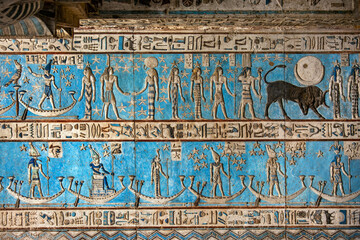Hieroglyphic carvings and paintings on the interior walls of an ancient egyptian temple