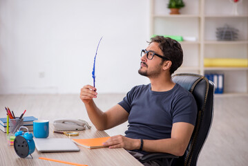 Young male designer working in the office