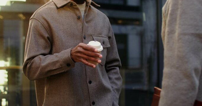 African American man talking with his interlocutor while standing outdoors