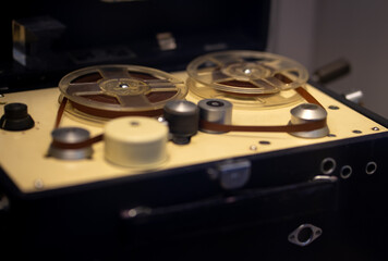 An old reel-to-reel tape recorder. Retro turntable with babines.