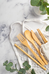 No plastic concept. Top view vertical photo of wooden cutlery fork spoon knife chopsticks white...