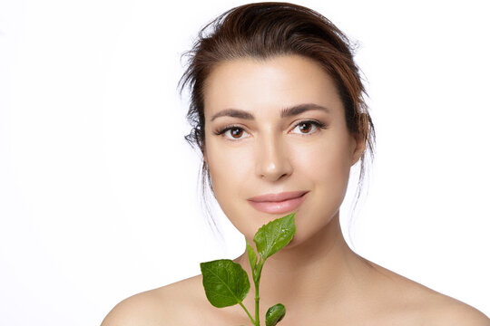 Beauty Spa Woman with a Fresh Leaf over Face