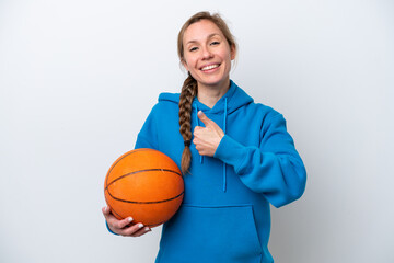Young caucasian woman playing basketball isolated on white background giving a thumbs up gesture