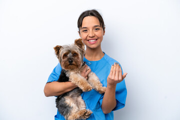 Young veterinarian woman with dog isolated on white background inviting to come with hand. Happy that you came