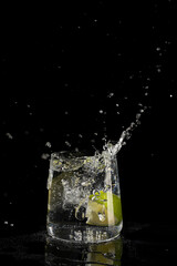 mojito cocktail on a black background with reflection