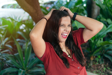 young woman in a red blouse in a green park