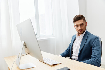 Fototapeta premium handsome businessman at the desk in the office an official Gray background
