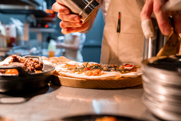 Male chef preparing focaccia on kitchen counter at luxurious holiday home