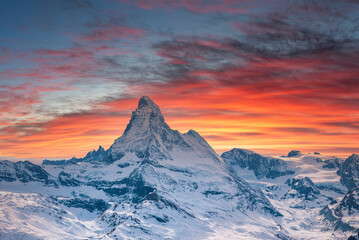 Idyllic Matterhorn mountain in alps against cloudy sky during sunset