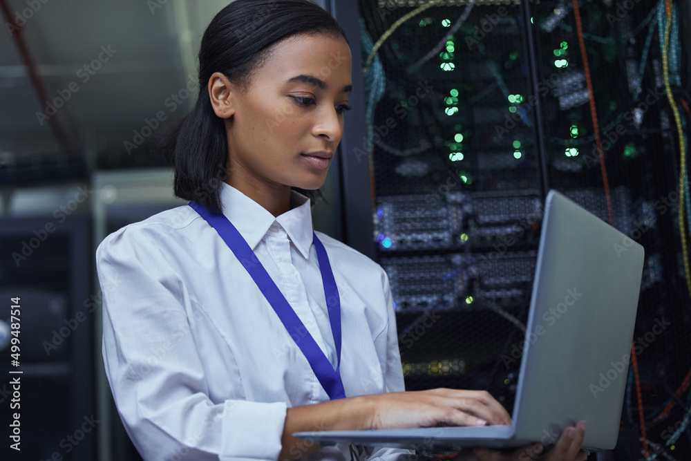 Poster checking the servers vitals. cropped shot of an attractive female it support agent working in a dark