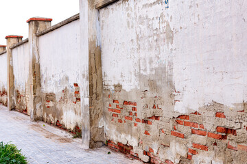 corrosion of the street wall. wet brick. rash plaster