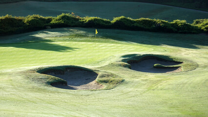 Overlooking the 15th hole of a golf course in morning light.