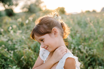 Happy little girl in the field of Queen Anne's Lace flower