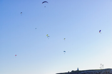 Paragliders flying in sky.