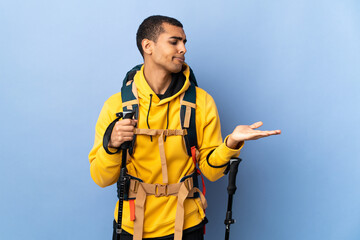 African American man with backpack and trekking poles over isolated background holding copyspace with doubts