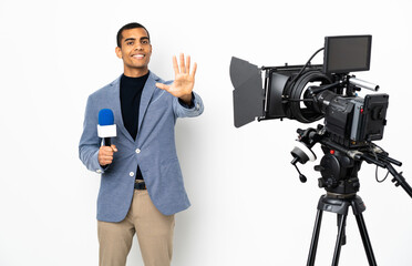 Reporter African American man holding a microphone and reporting news over isolated white background counting five with fingers