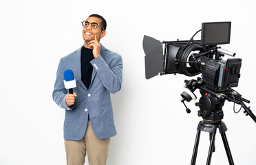 Reporter African American man holding a microphone and reporting news over isolated white background thinking an idea while looking up