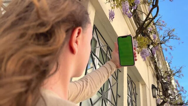 Chromakey Tracking or Green Screen. Adult Girl Touches Smartphone. Using Interactive Mobile Apps. Click buttons of modern Mobile Aplication, Interacting with Touchpad menu. High quality 4k footage