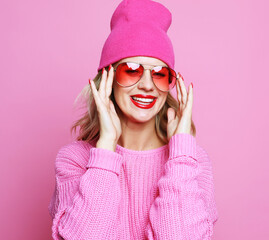 Stylish fashion portrait of trendy casual young woman in pink p