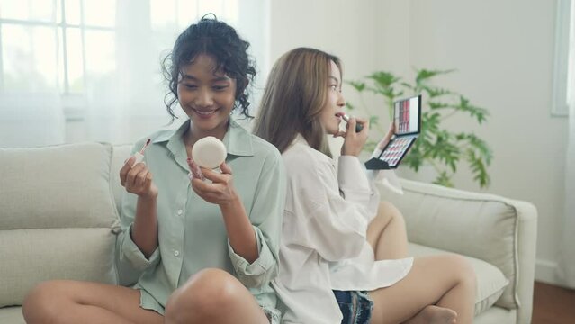 Beauty concept of 4k Resolution. Asian girls doing makeup together in the living room.