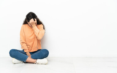 Teenager Russian girl sitting on the floor with headache