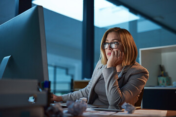 She just wants to get done. Cropped shot of a businesswoman working late at night in her office.