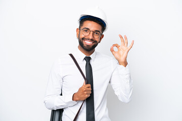 Young architect Brazilian man with helmet and holding blueprints isolated on white background showing ok sign with fingers