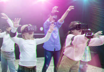 Group of happy tweens in VR glasses playing virtual reality games in special room in bright light rays. Toned image