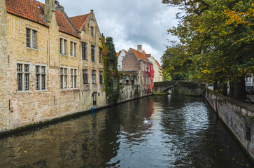 Fototapeta na wymiar The historical city center of Bruges with medieval brick houses along a canal 