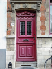 Fototapeta na wymiar Historical pink door into brick house
