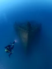 Wall murals Shipwreck   ship wreck underwater deep sea bottom metal on ocean floor scuba divers to explore