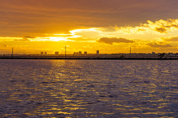 Sea coast and city skyline at sunset, Spain