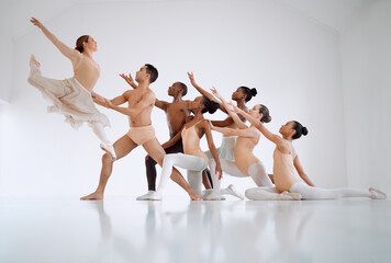 It requires training to attain perfection in this dance form. Shot of a group of ballet dancers practicing a routine in a dance studio.