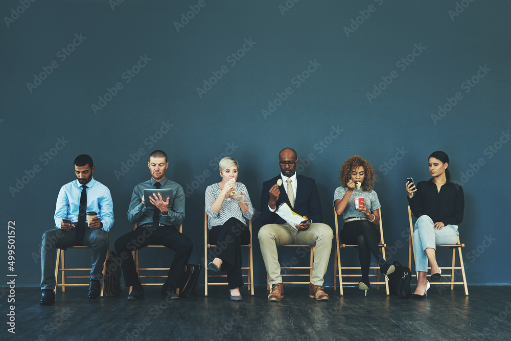 Aufkleber Do what you must to be prepared. Shot of a group of well-dressed business people seated in line while waiting to be interview.