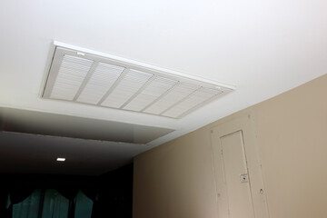 White Rectangle HVAC Air Return Vent Grill in a Home Ceiling - obrazy, fototapety, plakaty