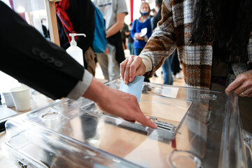 Illustration picture shows a person voting with a ballot paper in its envelope just before being...