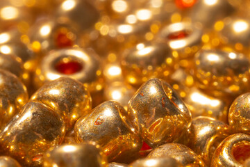Background beads macro photo. Gold beads close-up.