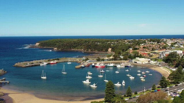 Ulladulla harbour on Pacific South coast of Australia in aerial back flying 4k.
