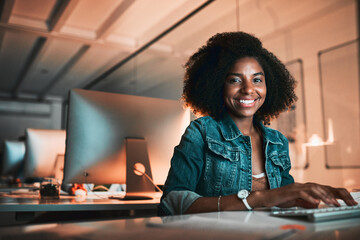 Im staying on top of things. Low angle portrait of an attractive young female designer working on...